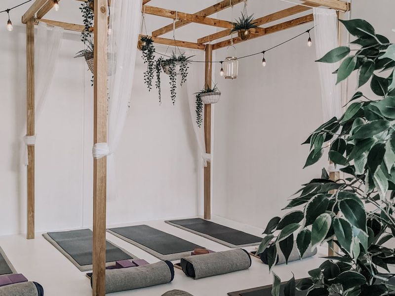 Serene yoga studio with natural light and minimalist decor.